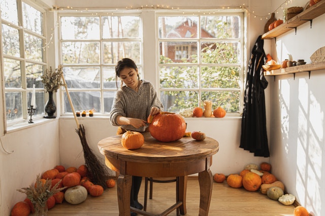 A girl carving out a pumpkin