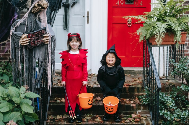 Two girls in Halloween costumes.