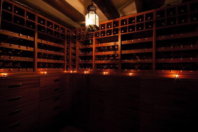 Soft light in a dark wine cellar.