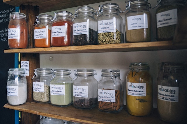 A collection of jars filled with various food items arranged neatly on shelves.