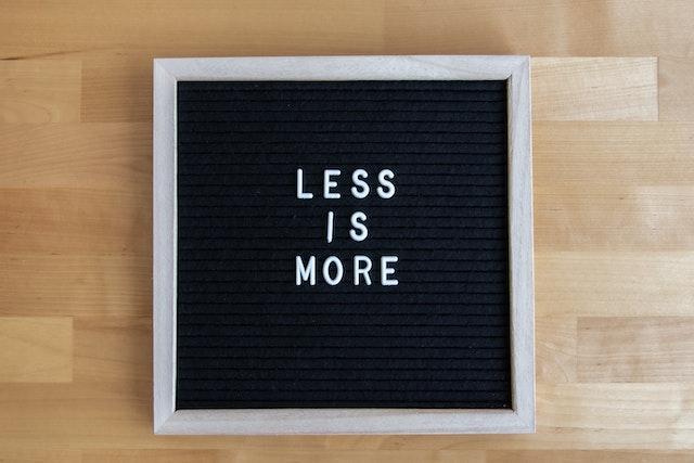 A sign that says Less is more