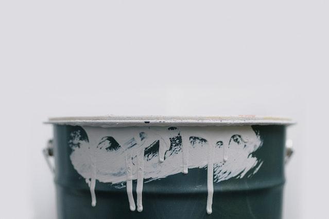 A metal can of white paint represents choosing the right paint colors for your home.