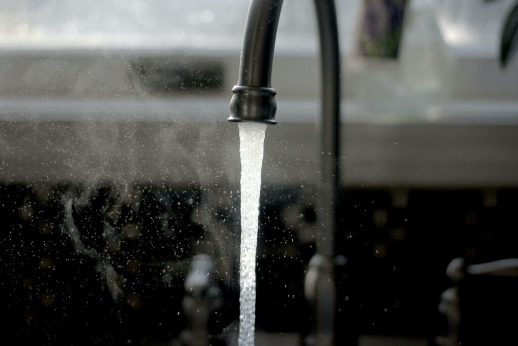 A faucet with water coming out of it.