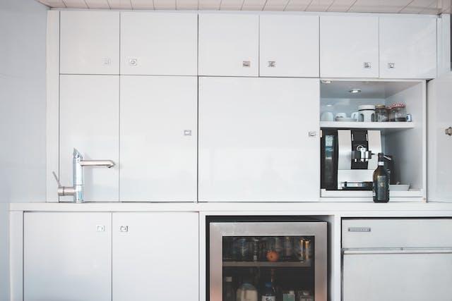 Contemporary kitchen with high gloss white cabinets and integrated appliances